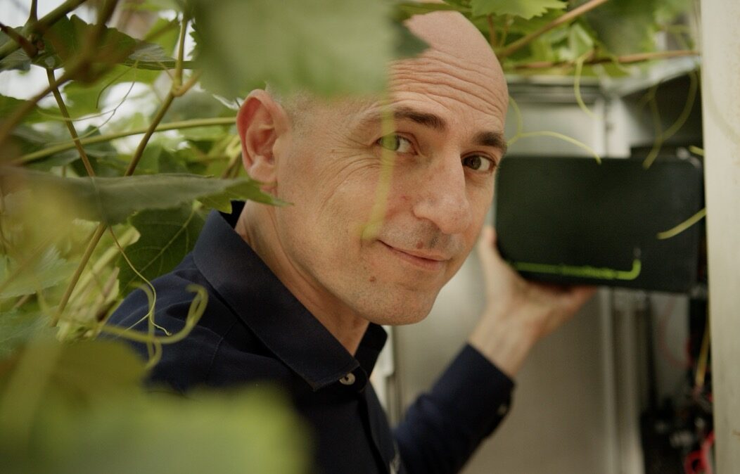 GrowDirector CEO Dima Chernobilsky holding a 4PRO sensor controller